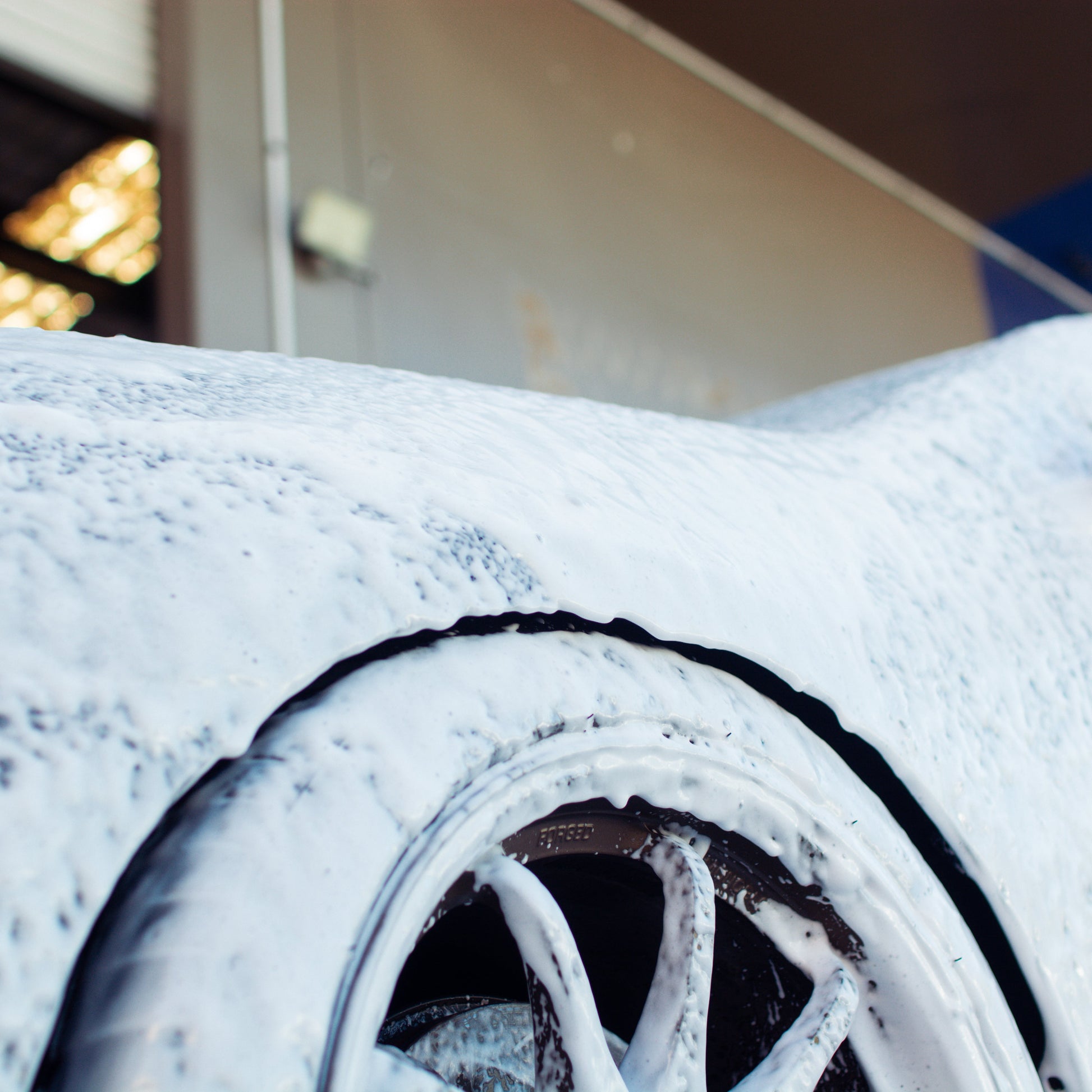Car covered in snow with a close-up of a wheel